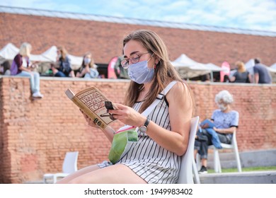 Buenos Aires, Argentina; April 2, 2021: Young Woman At A Reading Activity, Using Face Mask And Keeping Distance For The Prevention Of Covid, During The Felba, Publishers And Bookstores Fair