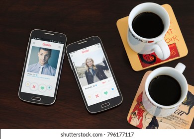 BUENOS AIRES, ARGENTINA - JANUARY 15, 2018: Two Cell Phones Over The Table, On The Screen Of Both Its Open The Tinder Application With A Profile Of A Men And A Woman Respectively. Online Dating.