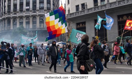 BUENOS AIRES, ARGENTINA - 
MARCH 24, 2022: People In A Procession Carrying An Indigenous Flag On The Day Of Remembrance For Truth And Justice