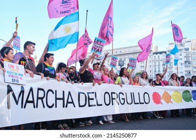 Buenos Aires, Argentina; Nov 6, 2021: LGBT Pride Parade. Group Of People Marching Holding A Banner With The Text Pride March And Persons With Posters, Comprehensive Trans Law Now.