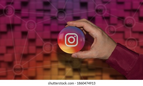 Buenos Aires, Argentina - November 24, 2020: A Hand Holding A Instagram Logo Glossy Badge Over Coloful Background