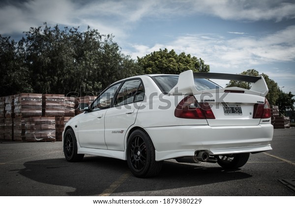 Buenos Aires, year 2015: Rear\
View of a white Mitsubishi Lancer Evolution IV. 90s japanese\
sportcar.