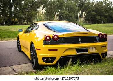 Buenos Aires, Year 2016: Rear view of yellow Ferrari 430 on the asphalt in a natural landscape.
