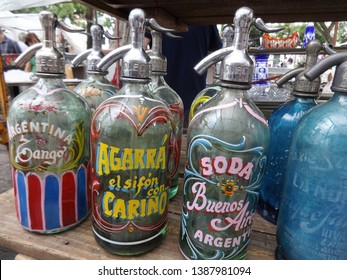 Buenos Aires/Argentina - January 15, 2017: Very Old Soda Bottles At The San Telmo Fair. Bottle Of Yellow Letters Is Written: Take The Sifon With Care.