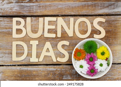 Buenos Dias (Good morning in Spanish) written with wooden letters, and Santini flowers 
