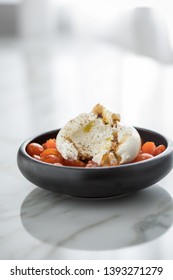 Buffalo Burrata Mozzarella Cheese Ball With Cocktail Tomatoes, Olive Oil And Balsamic Vinegar On Black Plate