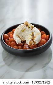 Buffalo Burrata Mozzarella Cheese Ball With Cocktail Tomatoes, Olive Oil And Balsamic Vinegar On Black Plate