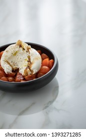 Buffalo Burrata Mozzarella Cheese Ball With Cocktail Tomatoes, Olive Oil And Balsamic Vinegar On Black Plate