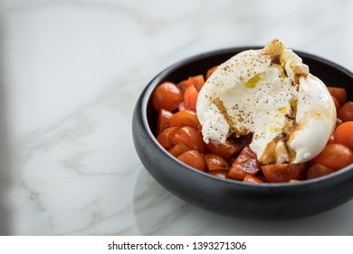 Buffalo Burrata Mozzarella Cheese Ball With Cocktail Tomatoes, Olive Oil And Balsamic Vinegar On Black Plate