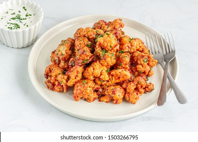 Buffalo Cauliflower Bites With Sauce On White Background. Popular Baked Cauliflower Wings On A White Plate.