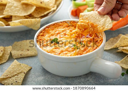 Buffalo chicken dip served with chips and fresh vegetables