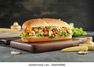 Buffalo Chicken Ranch Submarine Sandwich with Lettuce, green pepper. Tomato on a Crusty Bun. on cutting bored