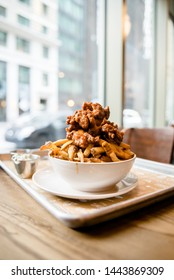 Buffalo Chicken Tenders On Top Of French Fries 