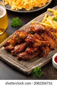 Buffalo Chicken Wings With Beer, French Fries On Wooden Board. Fast Food