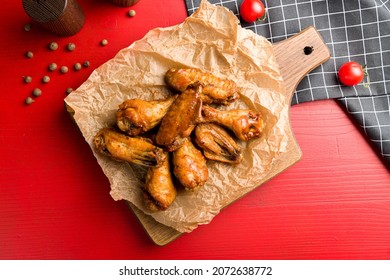 Buffalo Chicken Wings On The Board On Red Wooden Table Top View