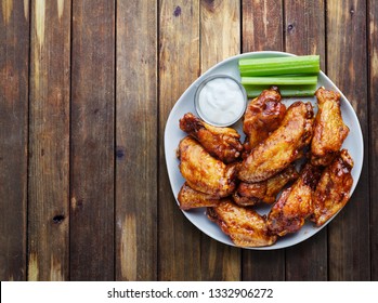 Buffalo Chicken Wings With Ranch And Celery In Overhead Composition Including Copyspace On Wooden Rustic Table Top