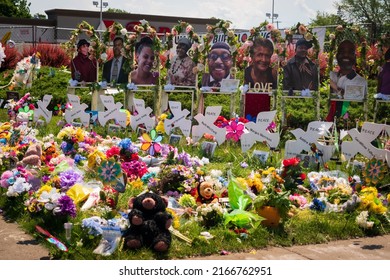 Buffalo, New York, USA- June 11, 2022: Memorial of flowers, dove cut-outs and pictures of the African American victims of the mass shooting in Buffalo NY at a Tops supermarket.