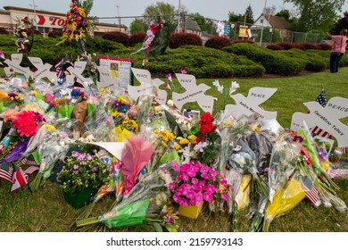 Buffalo, New York-May 21, 2022:  Memorial of flowers with dove cut-outs with the names of the victims of the mass shooting in Buffalo NY at a Tops supermarket.