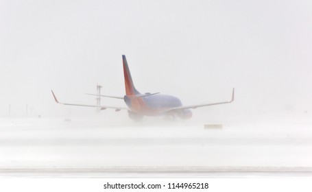 Buffalo, NY, USA - February 2nd, 2012: A Commercial Jet Performs A Dangerous Landing In Tough Weather Conditions With Fog And Snow At Buffalo Niagara International Airport