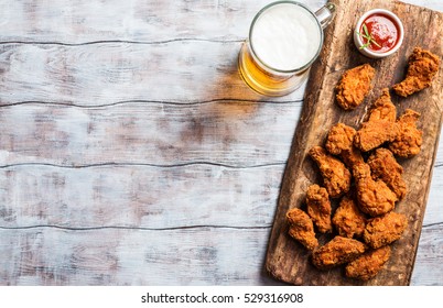 Buffalo style chicken wings served with cold beer, top view with copy space