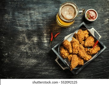 Buffalo style chicken wings served with cold beer, top view with copy space