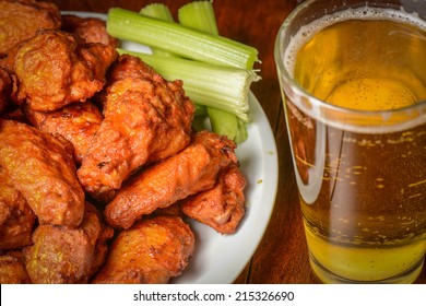 Buffalo Wings with Celery Sticks and Beer