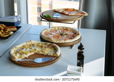 buffet with different dishes on the table with white tablecloths