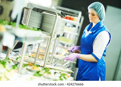 Buffet Female Worker Servicing Food In Cafeteria