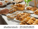 Buffet with a large selection of tartlets, cakes, buns at a catering event. Food for a coffee break at a conference.