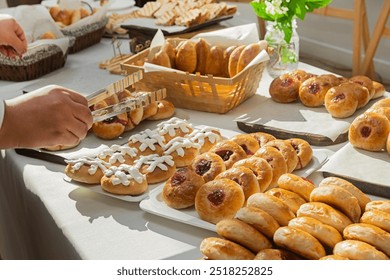 Buffet with a large selection of tartlets, cakes, buns at a catering event. Food for a coffee break at a conference.