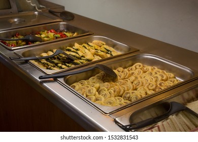 A Buffet Line - A Selection Of Food Displayed On A Long Table