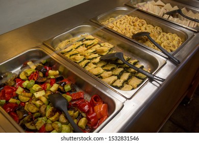 A Buffet Line - A Selection Of Food Displayed On A Long Table