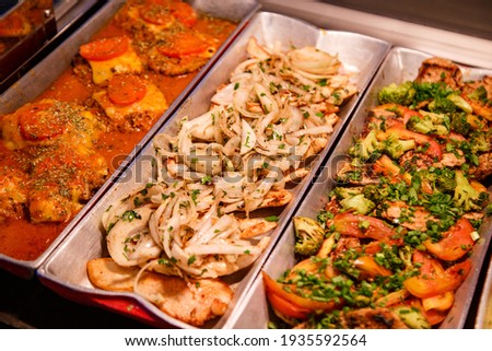 Buffet in restaurant, serving lunch or dinner for people to eat, diversity of delicious and tasty foods in a buffet, business food.