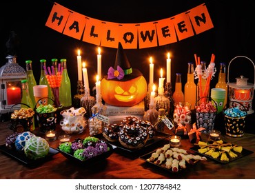 Buffet table with sweets and drinks, cooked  and decorated in honor of Halloween