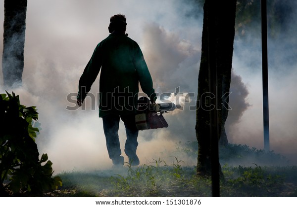 Bug Fumigation,\
man spraying an outside\
area.