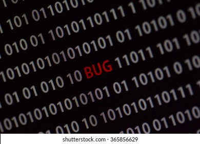 'Bug' word in the middle of the computer screen surrounded by numbers zero and one. Image is taken in a small angle.