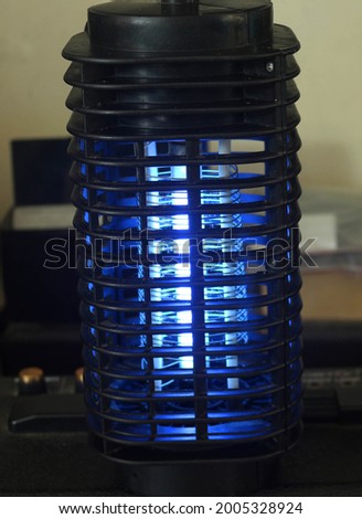 A bug zapper, or (insect) electrocutor trap, is a device that attracts and kills flying insects that are attracted by light. 