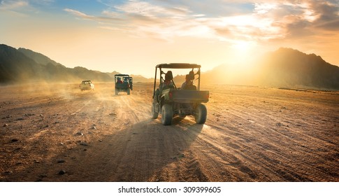 Buggies in sand desert at the sunset - Shutterstock ID 309399605
