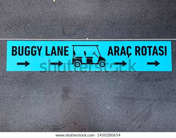 Buggy Lane\
with a symbol on the floor in English and Turkish language. Path\
for buggies only, to transport people fast from one point to the\
other. Free service of a good\
airport.