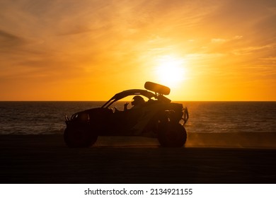 Buggy running at the beach at sunset