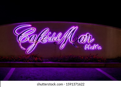 BUGIBBA, MALTA - OCTOBER 26, 2019: The Backlighted Logo Of The Café Del Mar In St Pauls Bay, Bugibba At Night Near The Complex Of Malta National Aquarium