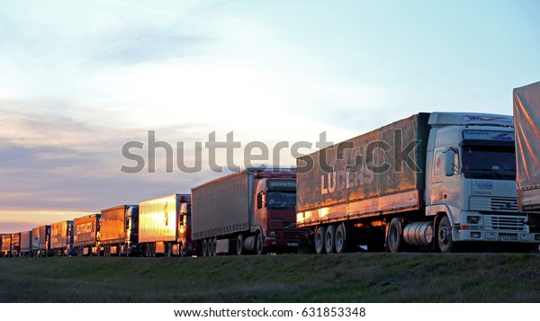 Bugristoe, Russia - April 29, 2017: Lorry trucks\
cars in traffic jam at border zone custom. Customs post Bugristoe,\
Russian-Kazakhstan border\
zone