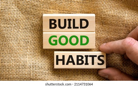 Build good habits symbol. Concept words Build good habits on wooden blocks on beautiful canvas background. Businessman hand. Copy space. Business, psychological build good habits concept.