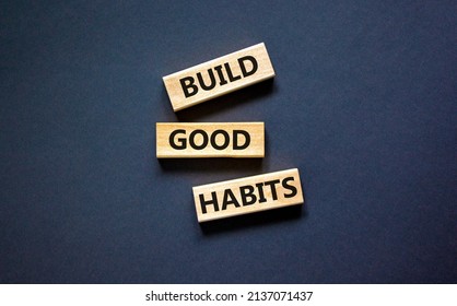 Build good habits symbol. Concept words Build good habits on wooden blocks on beautiful black table, black background, copy space. Business, psychological and build good habits concept.