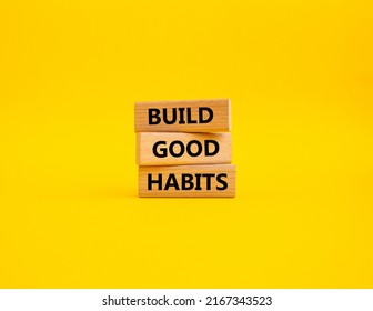 Build good habits symbol. Wooden blocks with words 'Build good habits'. Beautiful yellow background. Business and 'Build good habits' concept. Copy space. Conceptual image