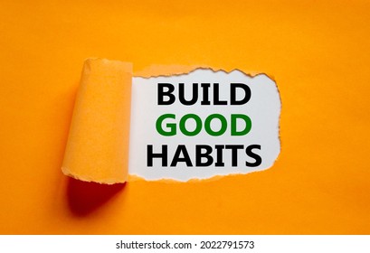 Build good habits symbol. Words 'Build good habits' appearing behind torn orange paper. Beautiful orange background. Business, psychology and build good habits concept, copy space.