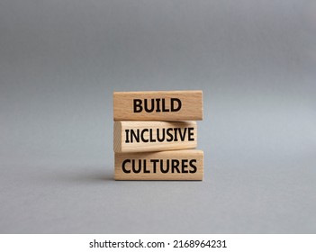 Build Inclusive Cultures symbol. Wooden blocks with words Build Inclusive Cultures. Beautiful grey background. Business and Build Inclusive Cultures. Copy space.