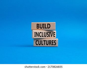 Build Inclusive Cultures symbol. Wooden blocks with words Build Inclusive Cultures . Beautiful blue background. Business and Build Inclusive Cultures. Copy space.. Conceptual image