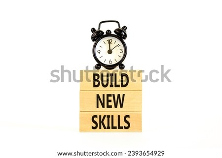 Build new skills symbol. Concept word Build new skills on beautiful wooden block. Black alarm clock. Beautiful white table white background. Business, education build new skills concept. Copy space.