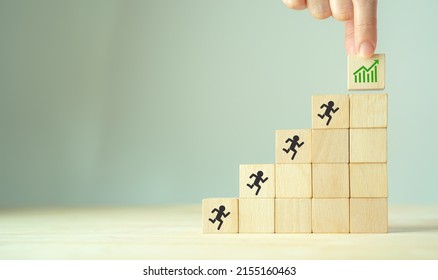 Build a successful team concept. Teamwork running to goal and achieving successful business. Thriving teams creating thriving organisation. Growth performance icon on wooden cube with grey background.